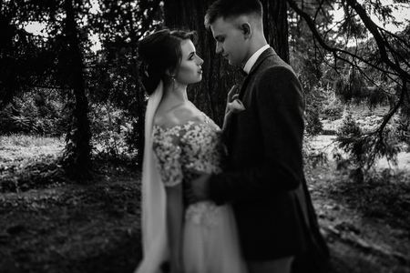 Beautiful young couple walking in the autumn park smiling brightの写真素材
