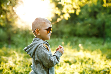 Stylish little boy in sunglasses and fashionable clothes . Childの写真素材