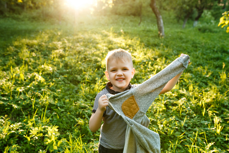 Autumn portrait of a cute little boy of 3 years old, playing inの写真素材