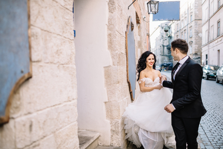 Portrait of a romantic beautiful couple traveler walking in the old townの写真素材