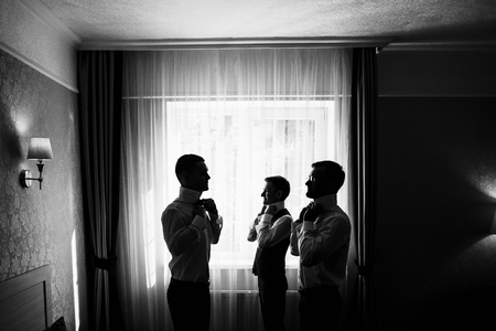Three handsome male friends meet and speeking each other. Groomsの写真素材
