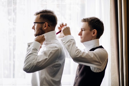 Three handsome male friends meet and speeking each other. Groomsの写真素材
