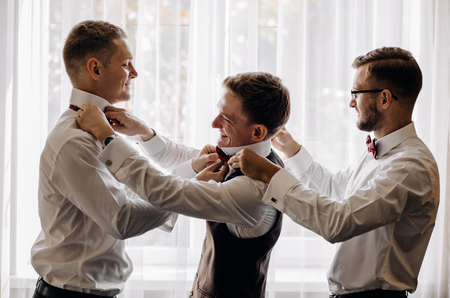 Three handsome male friends meet and speeking each other. Groomsの写真素材