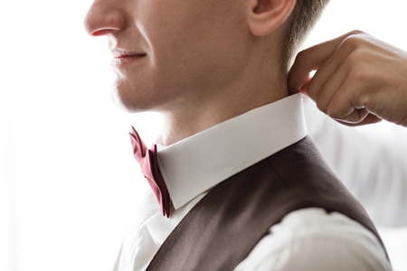 stylish groom laughing and having fun with groomsmen while gettiの写真素材
