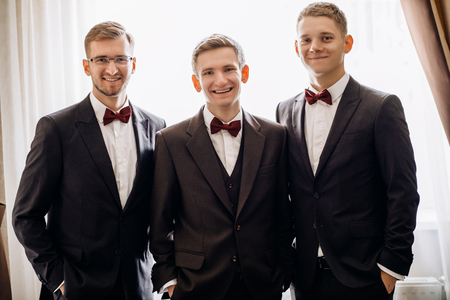 Three handsome male friends meet and speeking each other. Groomsの写真素材