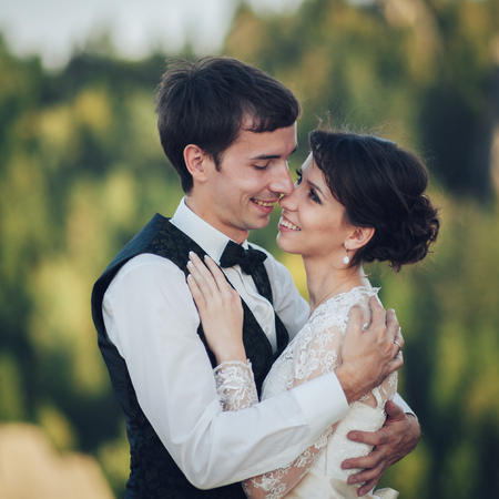 Luxury wedding couple is hugging each other in mountainsの写真素材