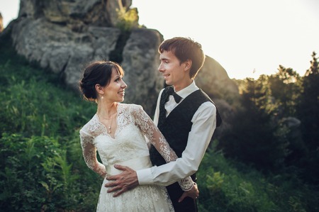 Amazing wedding couple is hugging each other in mountainsの写真素材