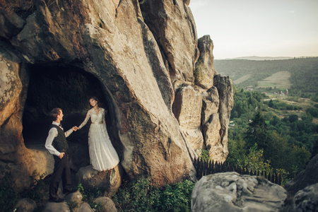 Amazing wedding couple is hugging each other in mountainsの写真素材