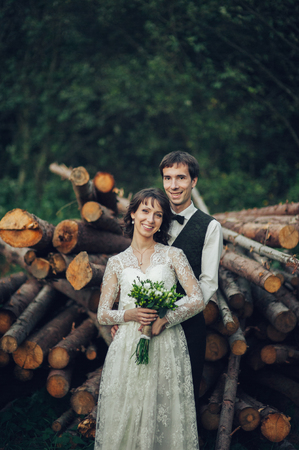 Gorgeous bride and stylish groom walking at sunny landscape, wedの写真素材