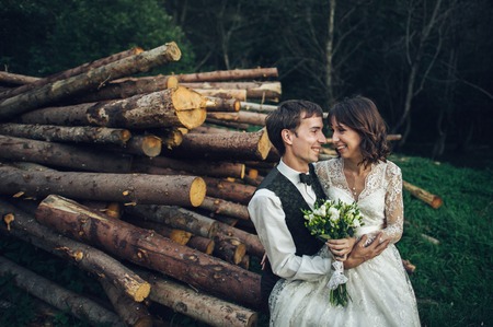 Gorgeous bride and stylish groom walking at sunny landscape, wedの写真素材