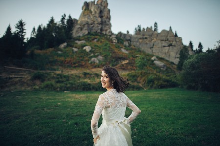 Woman in white poses in the gardenの写真素材