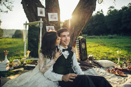 Attractive Couple Enjoying Romantic Sunset Picnic in the Countryの写真素材