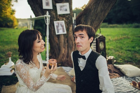 distant view of young caucasian engaged couple on romantic picnicの写真素材