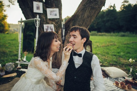 distant view of young caucasian engaged couple on romantic picnicの写真素材