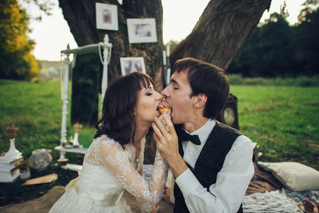 distant view of young caucasian engaged couple on romantic picnicの写真素材