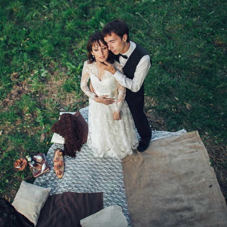 Attractive Couple Enjoying Romantic Sunset Picnic in the Countryの写真素材