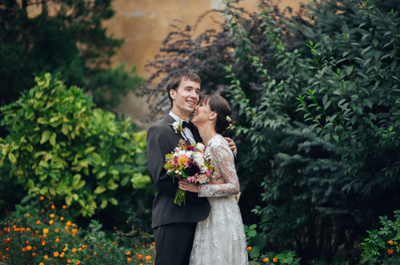 Happy bride and groom at a park on their wedding dayの写真素材