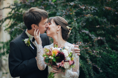 Happy bride and groom at a park on their wedding dayの写真素材