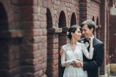 Happy bride and groom at a park on their wedding dayの写真素材