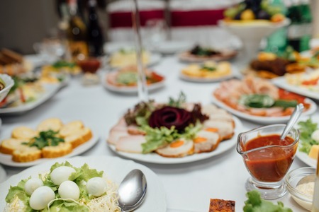 Tasty meat and vegetable snacks on the wedding tableの写真素材
