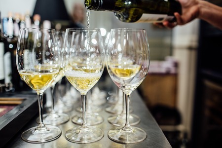 waiter brings glasses of champagneの写真素材