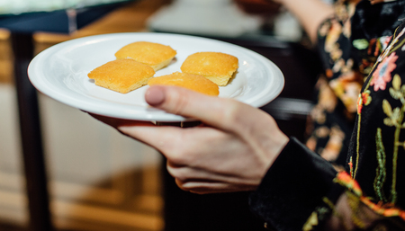 women holds a plates with food on backgroundの写真素材