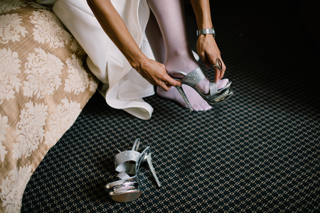 Bride in the dress in the white bridal shoesの写真素材