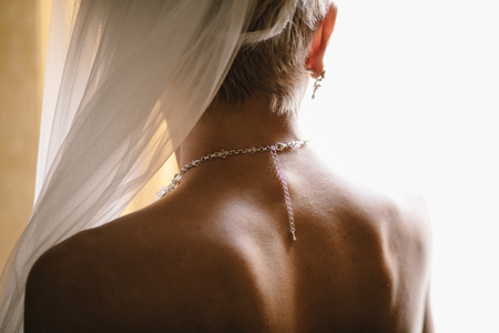 Bride in the nice earrings next to the windowの写真素材