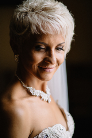Bride in the nice earrings next to the windowの写真素材