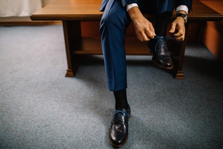 Dressing groom and preparing for ceremonyの写真素材