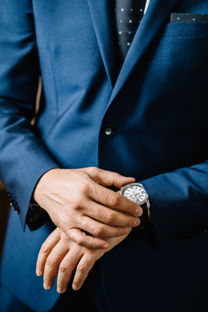 Dressing groom and preparing for ceremonyの写真素材