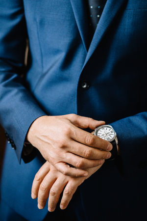Dressing groom and preparing for ceremonyの写真素材