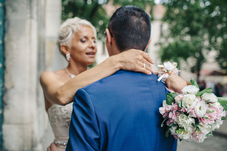 Woman kisses mans nose tenderの写真素材