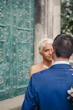 Beautiful sensual bride hugging handsome groom closeupの写真素材