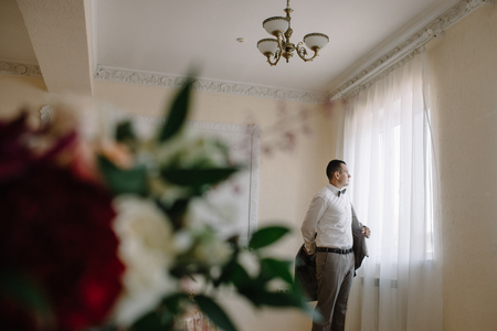 Dressing groom and preparing for ceremonyの写真素材