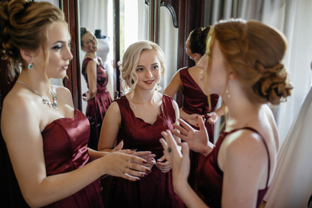 Lovely bride and bridesmaids next to the big windowの写真素材