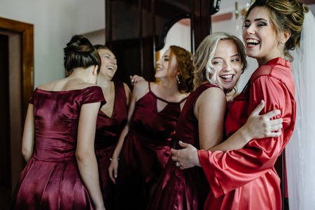 Lovely bride and bridesmaids next to the big windowの写真素材