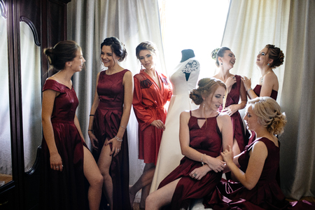 Lovely bride and bridesmaids next to the big windowの写真素材