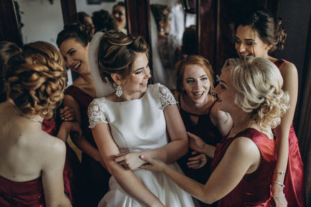 Lovely bride and bridesmaids next to the big windowの写真素材