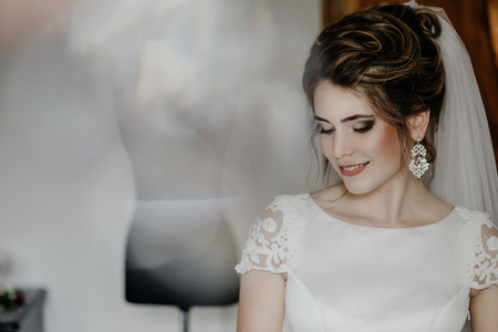 Closeup shot of an elegant, brunette bride in vintage white dresの写真素材
