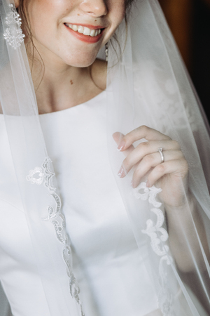 Closeup shot of an elegant, brunette bride in vintage white dresの写真素材