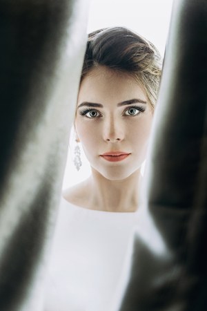 Closeup shot of an elegant, brunette bride in vintage white dresの写真素材