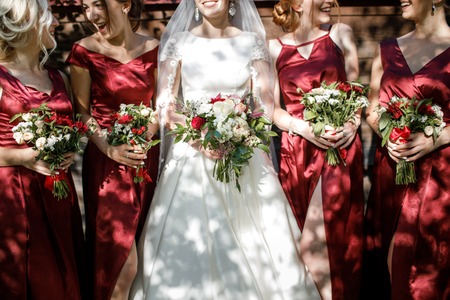 Bride with bridesmaids on the park on the wedding dayの写真素材