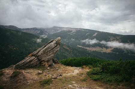 Strange rocks in mountains in cloudy dayの写真素材