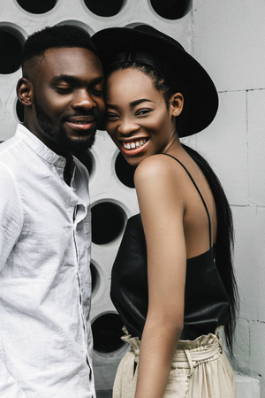Modern black man and caucasian woman in a town.の写真素材