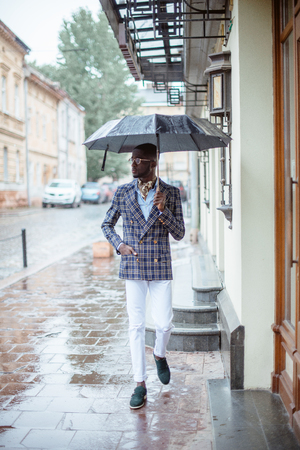 Urban portrait of handsome African American businessman standingの写真素材