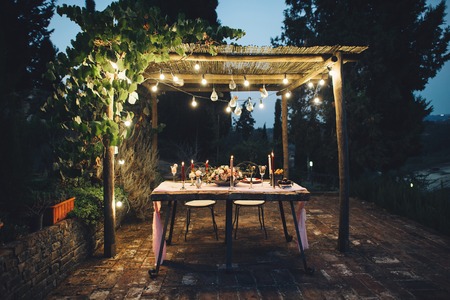 Decorated outdoor wedding table with flowers in rustic styleの写真素材