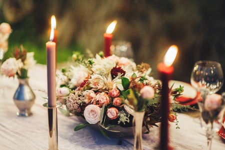 Decorated outdoor wedding table with flowers in rustic styleの写真素材