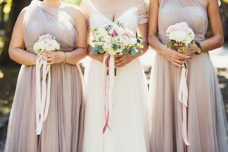 Bride and bridesmaids with autumn bouquetsの写真素材
