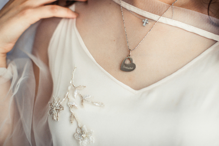 Young bride hodls her hands before her mouth posing before brighの写真素材